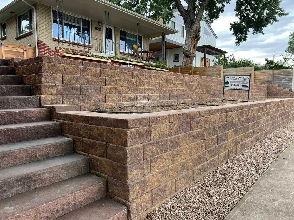 Block retaining wall with built-in steps up to the house