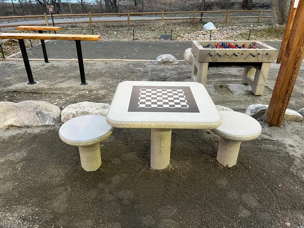 Cast concrete chess table and benches set in decomposed granite