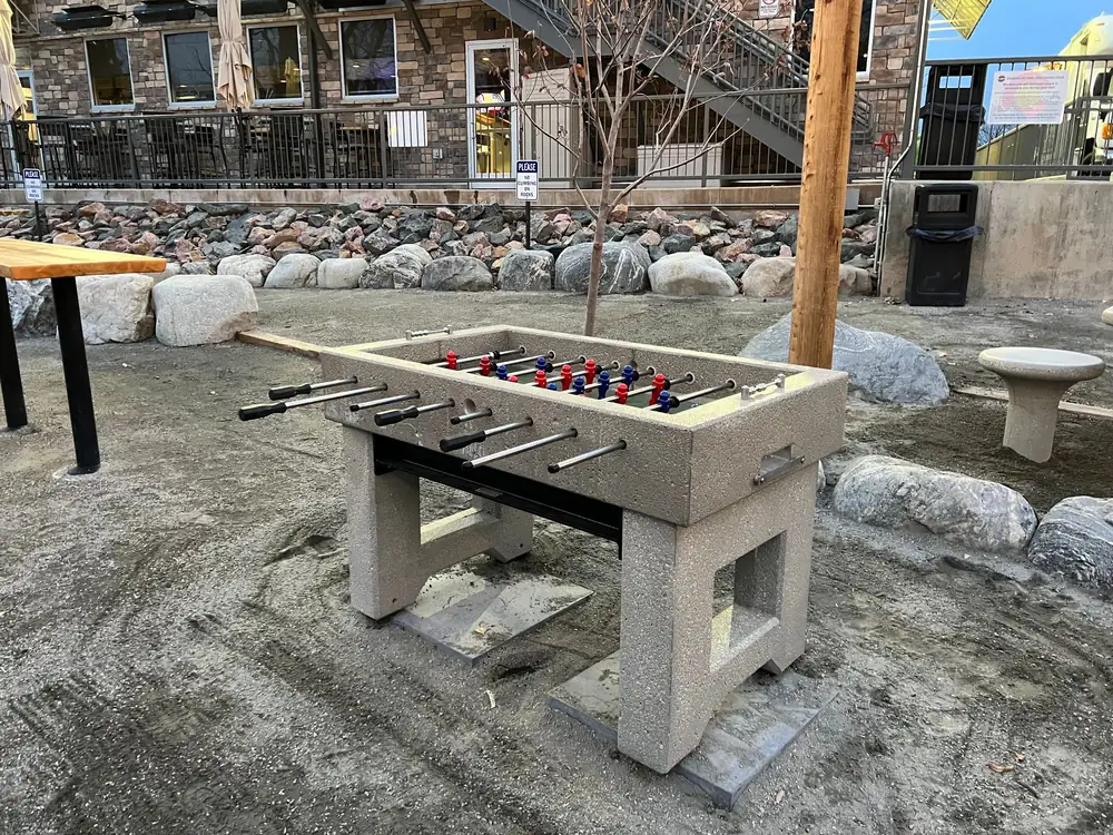 Cast concrete foosball table on a crushed gravel pad