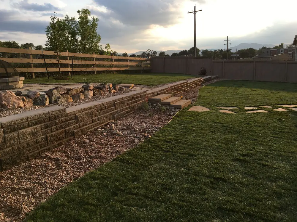 Long block retaining wall with stepping stones and new sod