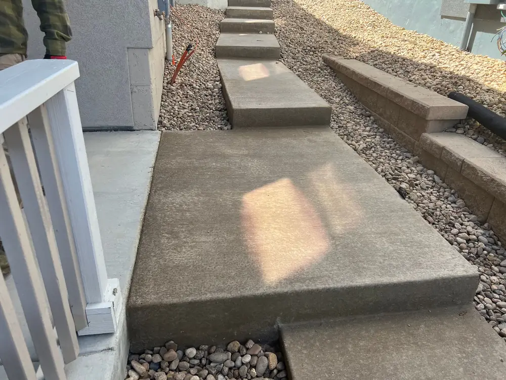 Concrete side-yard steps between gravel beds